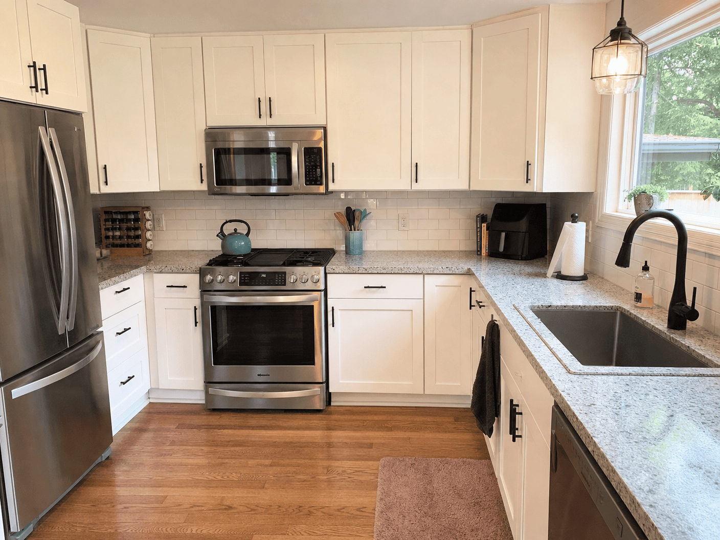 Clean white kitchen with polished counters and appliances